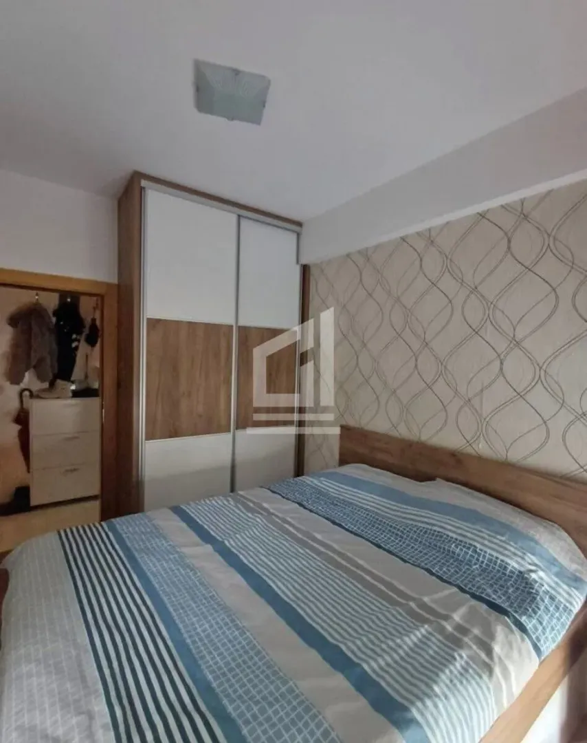 Bedroom with a double bed and a fitted wardrobe.