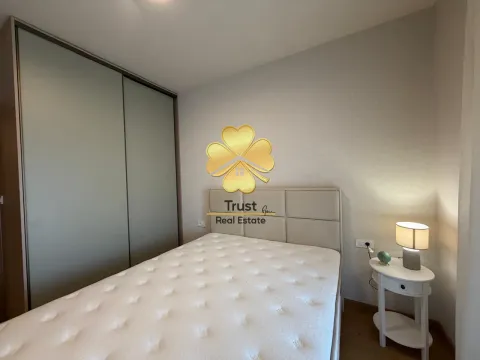 Modern bedroom with a double bed, wardrobe, and a nightstand. - image 10