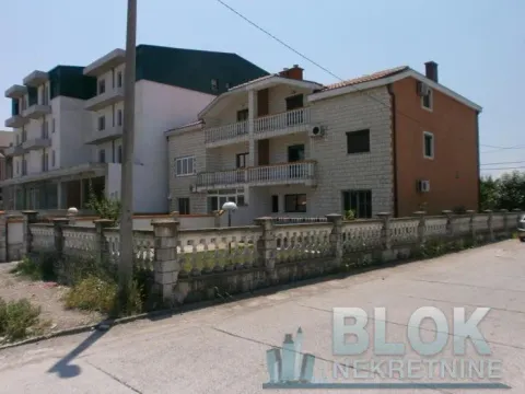 Exterior view of the house with a courtyard and fence. - image 8