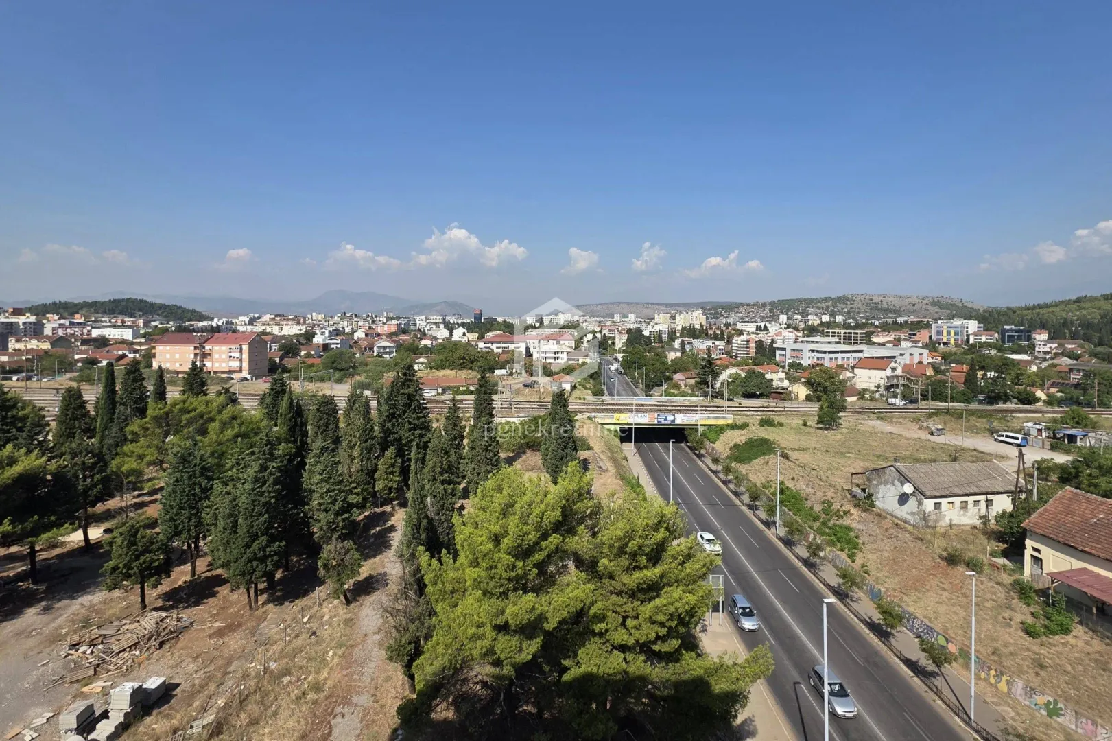 Aerial view of the city with a main road and surrounding area.