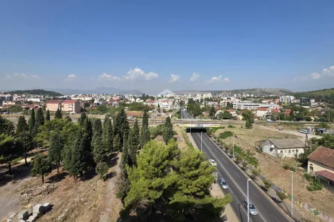 Aerial view of the city with a main road and surrounding area. - image 15