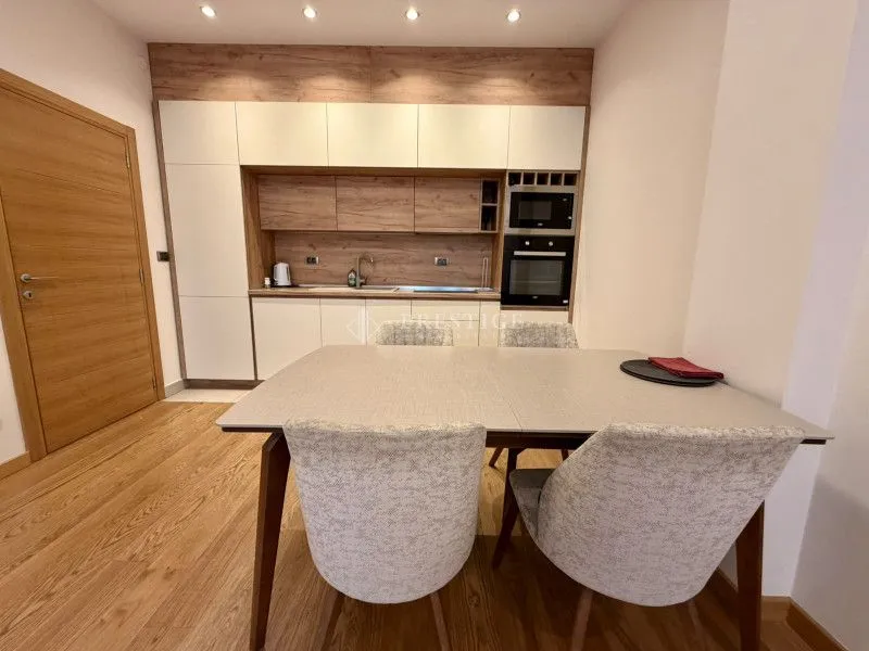 Modern kitchen with a dining area and built-in appliances.