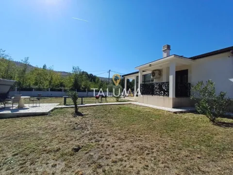 View of the yard and exterior of the house with a paved terrace. - image 13