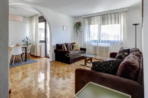 Living room with a sofa set and a dining area in the background. - image 18