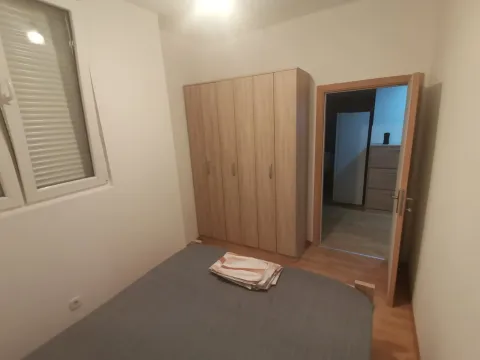 Simply furnished bedroom with a wardrobe. - image 6