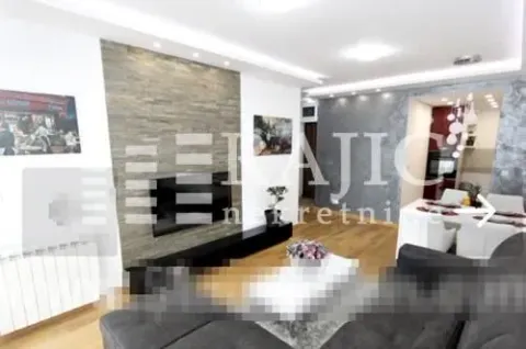 Modern living room with a stone wall cladding and dining area in the background. - image 2