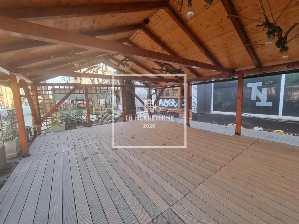 Covered wooden terrace with wooden flooring.