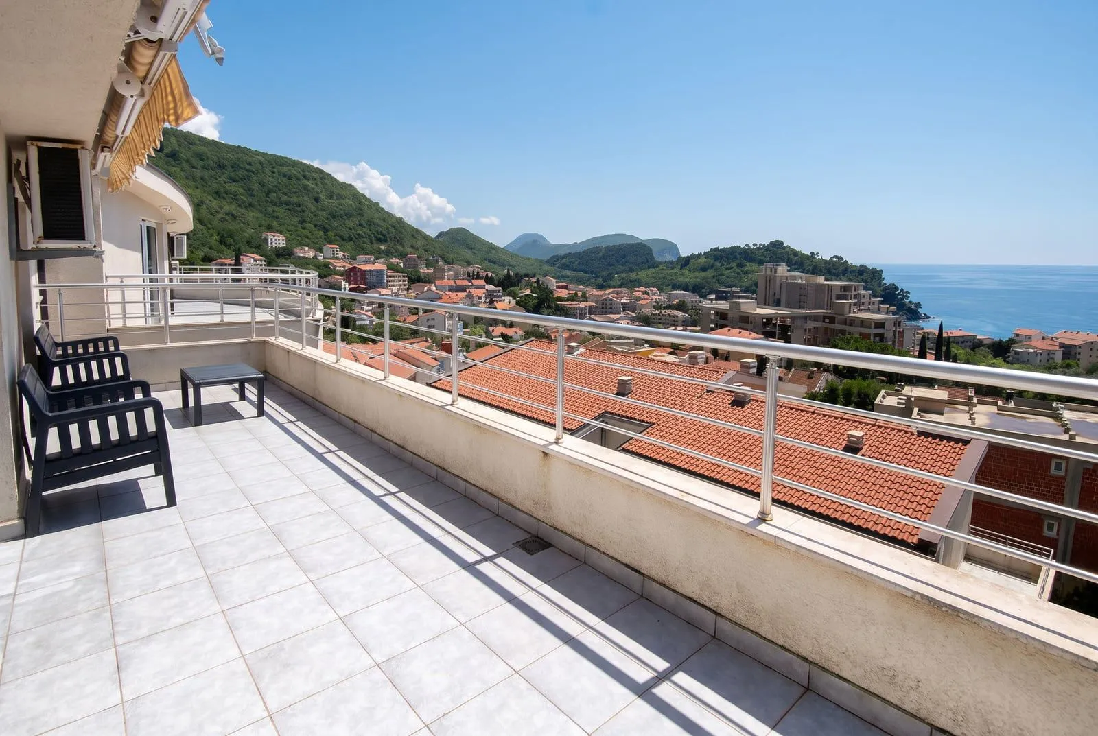 Spacious balcony with a view of the sea and the town.