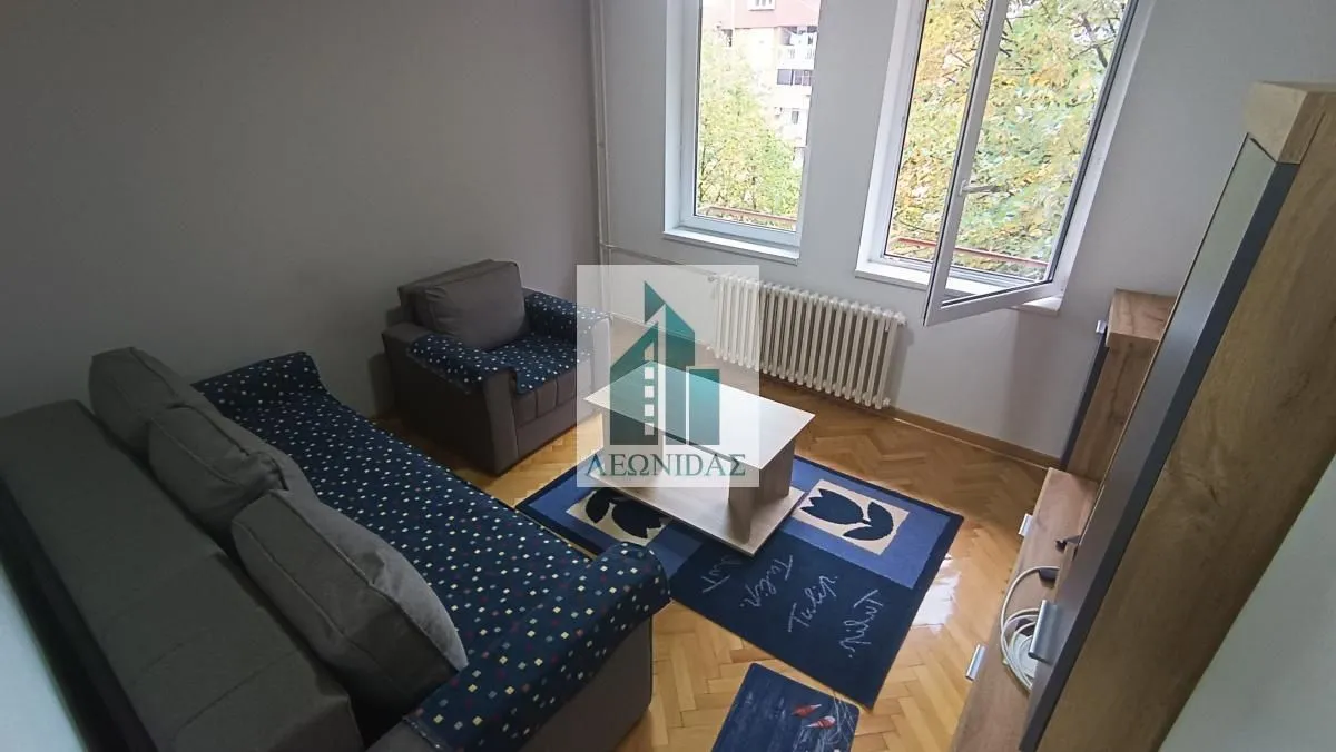 Living room with sofa and window.