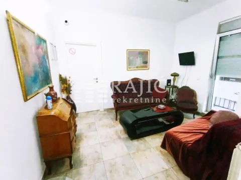 Living room with a sofa set, coffee table, and cabinetry. - image 4