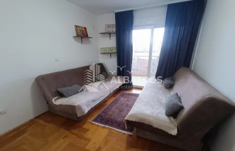 Living room with two sofas, parquet flooring, and balcony access. - image 5
