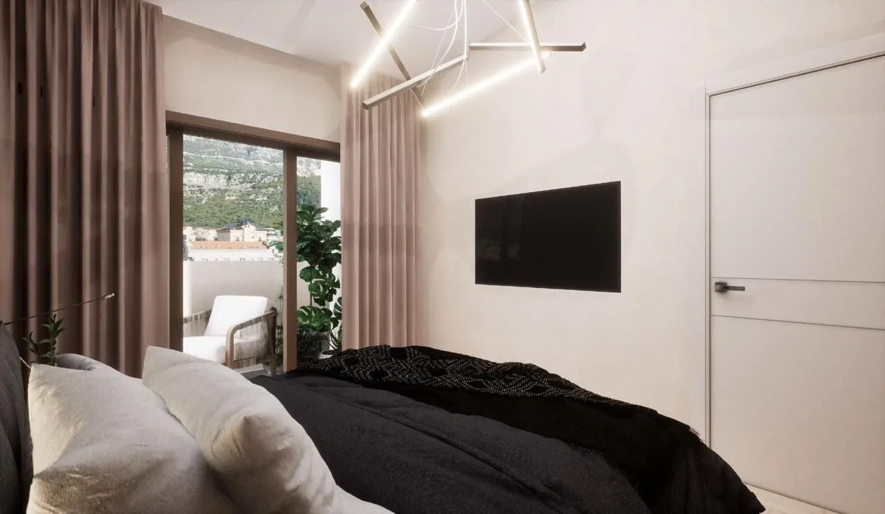 Modern bedroom with a double bed, wall-mounted TV, and access to the terrace.