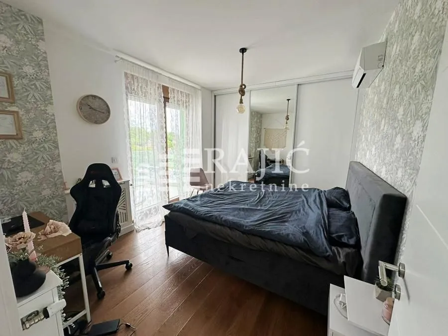 Furnished bedroom with a double bed, desk, and wardrobe.