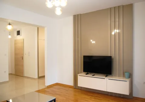 Living room with a TV unit and decorative wall panel. - image 13
