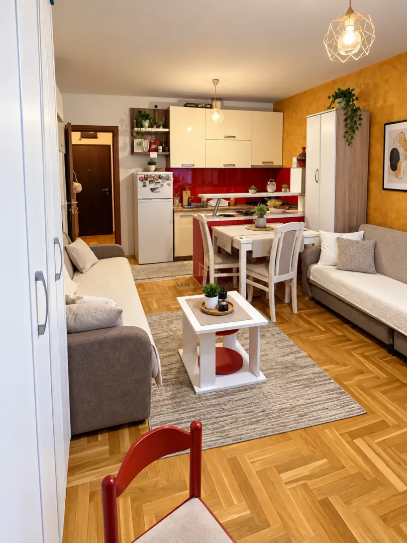Living room with open-plan dining area and kitchen.