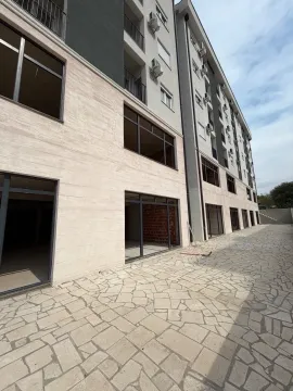 Exterior view of a modern residential building with a paved courtyard. - image 5
