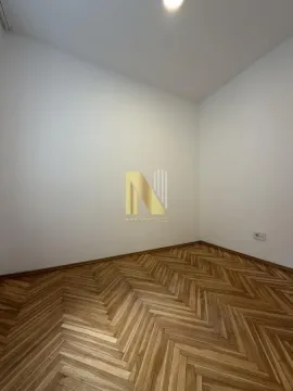 Empty room with wooden parquet flooring and white walls. - image 6