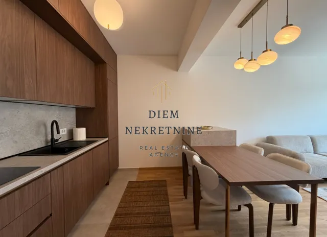 Modern kitchen with wooden cabinetry and a dining area.