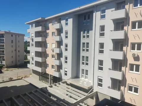 Exterior of a modern residential building with balconies under a clear sky. - image 2