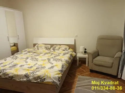 Bedroom with a double bed, wardrobe and an armchair. - image 4