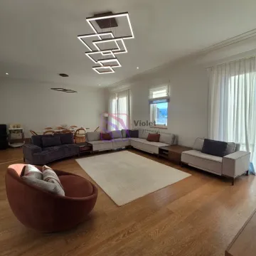 Spacious living room with a seating set and a dining area in the background. - image 3