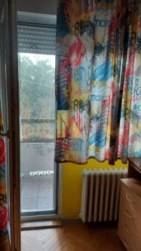 Pogled na izlaz na terasu sa šarenim zavesama i parketom. - image 10