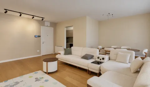 Spacious living room with a sectional sofa and a dining area in the background. - image 6