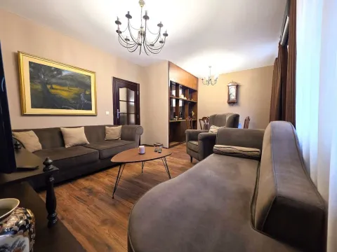 Spacious and furnished living room with a sofa set and dining area in the background. - image 2