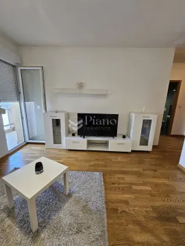 Living room with a TV unit and access to the terrace. - image 2