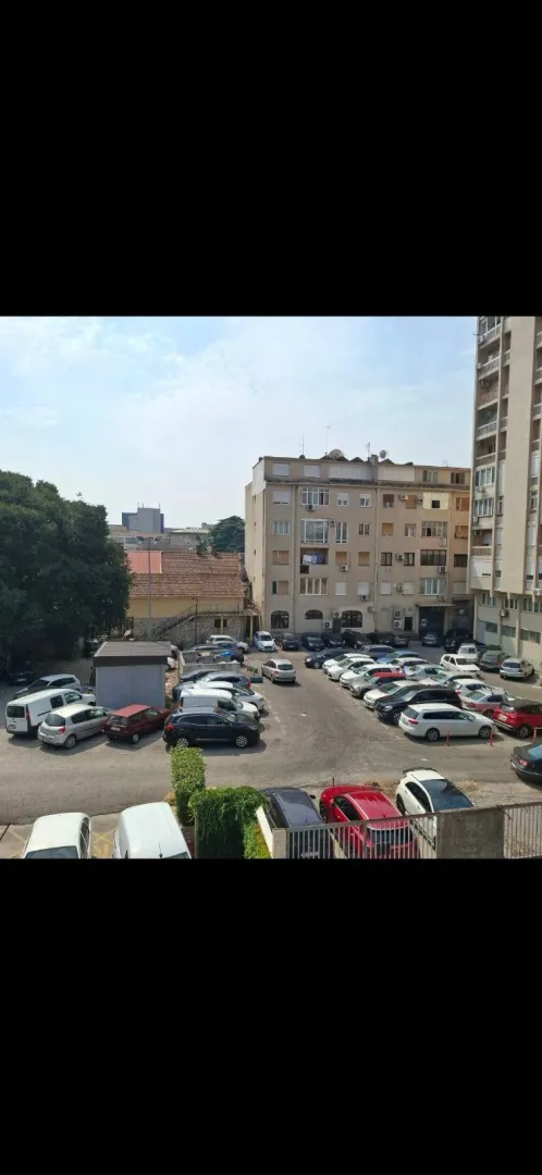 View from the terrace overlooking the parking lot and surrounding buildings.