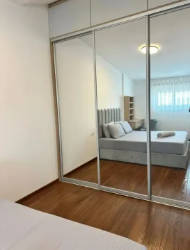 Bedroom with a large fitted mirrored wardrobe and a double bed. - image 15