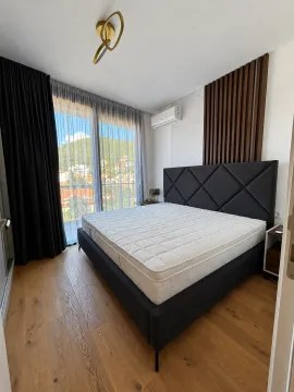 Modern bedroom with a large double bed and access to the terrace. - image 8