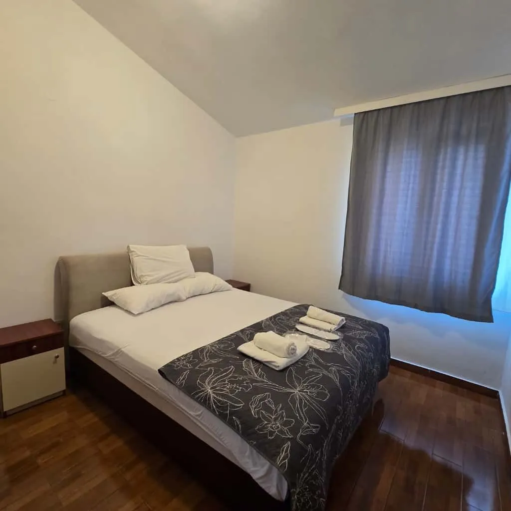 Bedroom with a double bed and a nightstand.