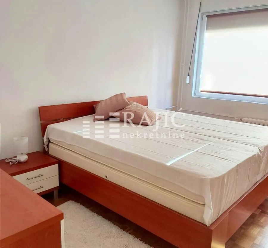 Bedroom with a double bed and a nightstand.