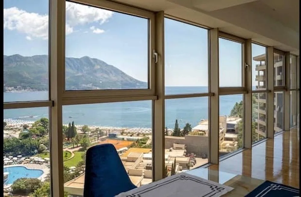 Living room with large glass surfaces and a sea view.