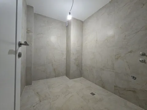 Modern tiled bathroom with a walk-in shower area under furnishing. - image 12