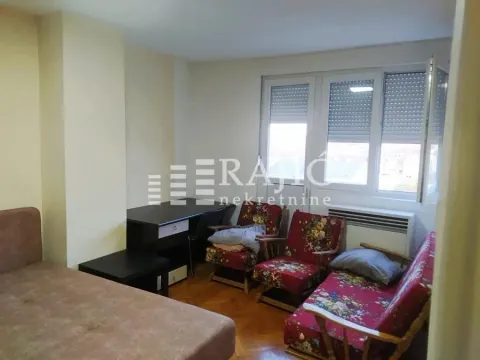 Furnished bedroom with a bed, armchairs, and a desk. - image 3
