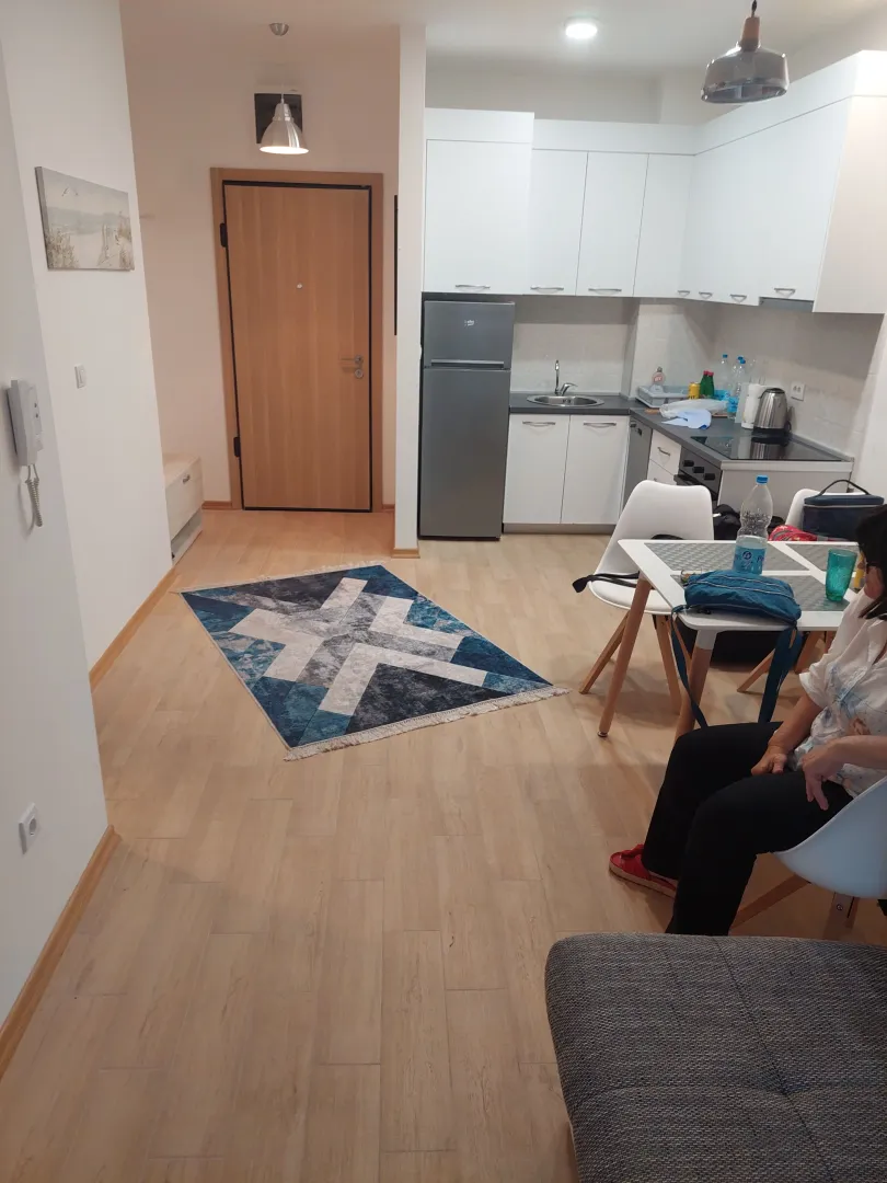 Living room with dining area and kitchen in the background.