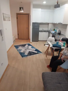 Living room with dining area and kitchen in the background. - image 8