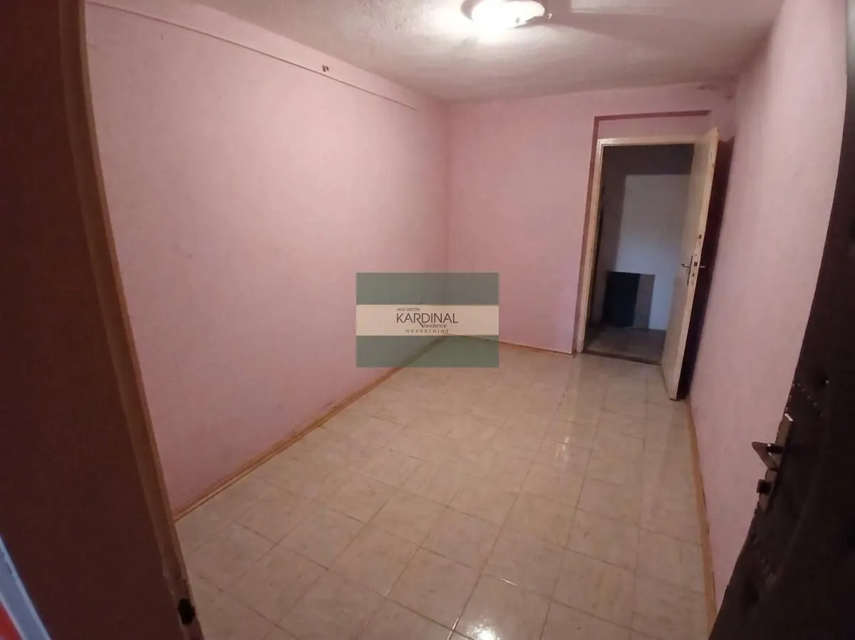 Empty room with tiled flooring and pink walls.
