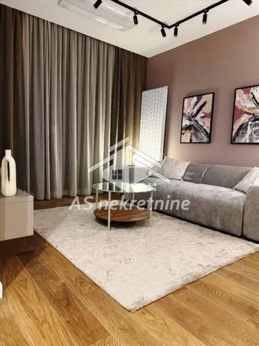 Modern living room with a sectional sofa, coffee table, and decorative wall art.
