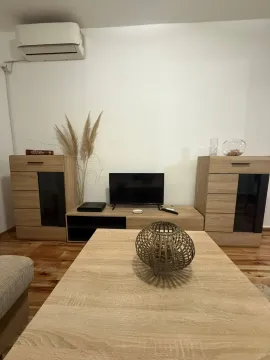 Living room with wooden furniture and a television. - image 4