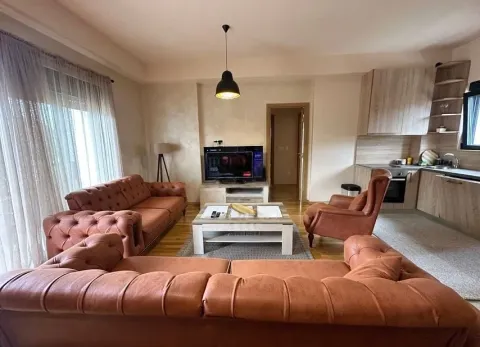 Living room with a sofa set and TV connected to the kitchen. - image 14