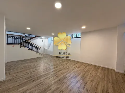 Spacious empty room with wooden flooring and a staircase. - image 11