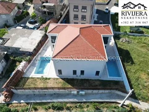 Aerial view of the house with a tiled roof and a courtyard with a swimming pool. - image 17