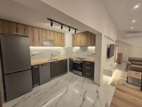 Modern kitchen with wooden cabinets and built-in appliances. - image 5