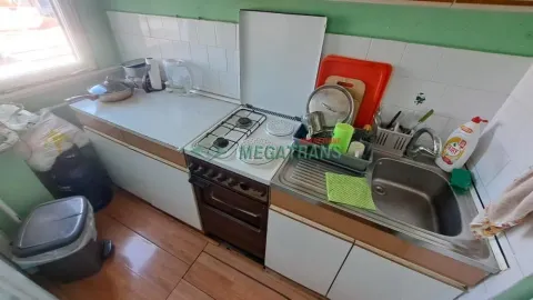 Small kitchen with a stove, sink, and kitchen units. - image 2