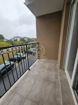 Covered balcony space with tiles and a view of the parking area and surroundings. - image 7