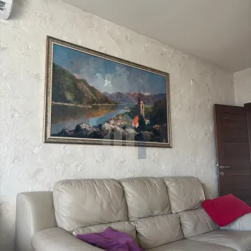 Living room with light sofa and artwork on the wall. - image 5