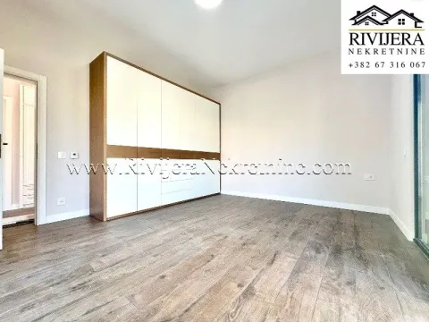 Bedroom with a large built-in wardrobe and wooden flooring. - image 12